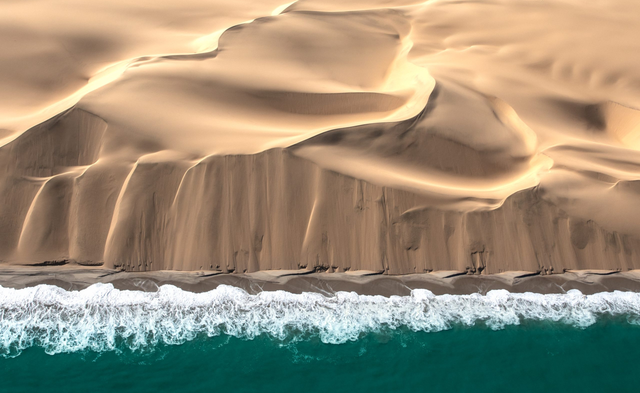 Aerial,View,Of,Skeleton,Coast,Sand,Dunes,Meeting,The,Waves